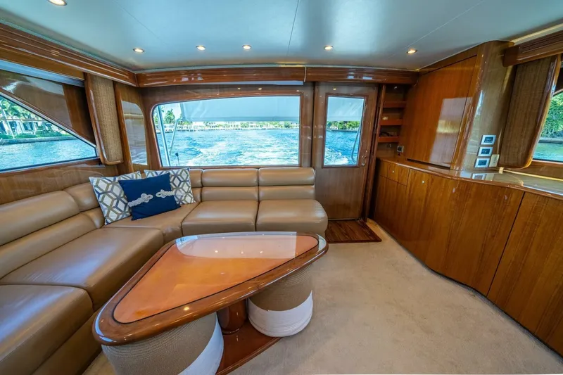 Running Over Yacht Photos Pics Luxurious interior of a 2006 Viking 68 Convertible yacht with leather seating and wooden finishes.
