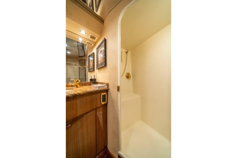 Running Over Yacht Photos Pics Luxurious bathroom in 2006 Viking 68 Convertible yacht with elegant fixtures and wood cabinetry.