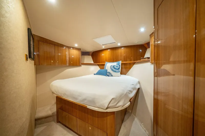 Running Over Yacht Photos Pics Luxurious cabin interior of 2006 Viking 68 Convertible yacht with wooden finishes.
