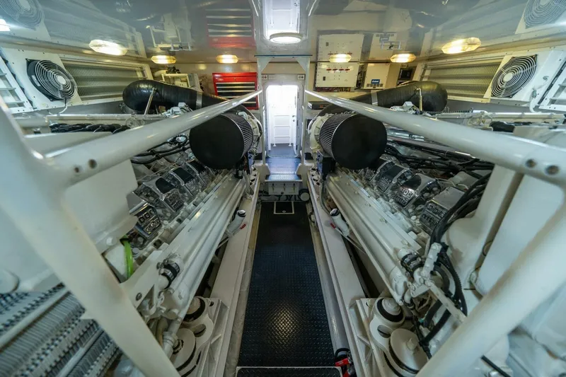 Running Over Yacht Photos Pics Engine room of 2006 Viking 68 Convertible yacht, showcasing dual engines and mechanical systems.