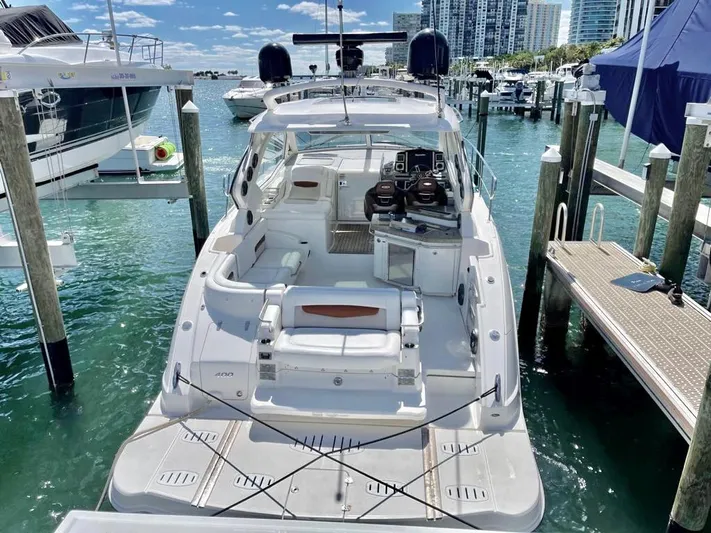  Yacht Photos Pics 2010 Chaparral Premiere 400 yacht docked at marina, clear skies, modern design.