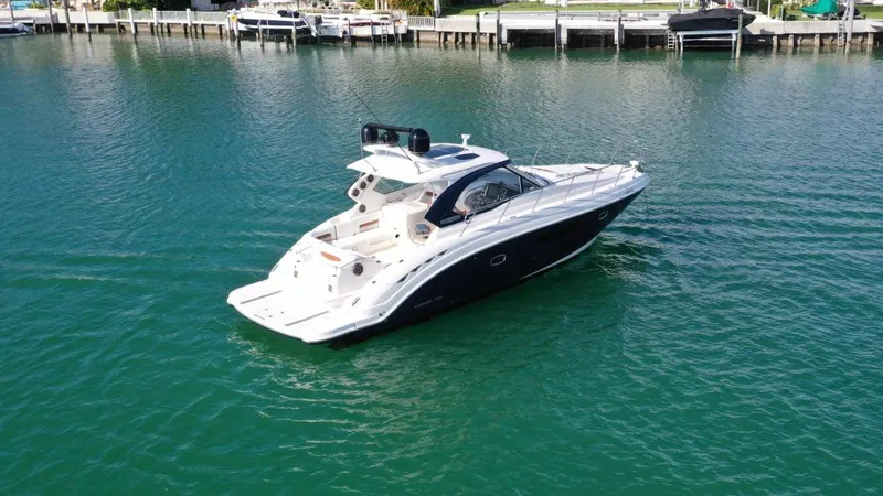  Yacht Photos Pics Chaparral Premiere 400 yacht, 2010 model, cruising on calm waters near a marina.
