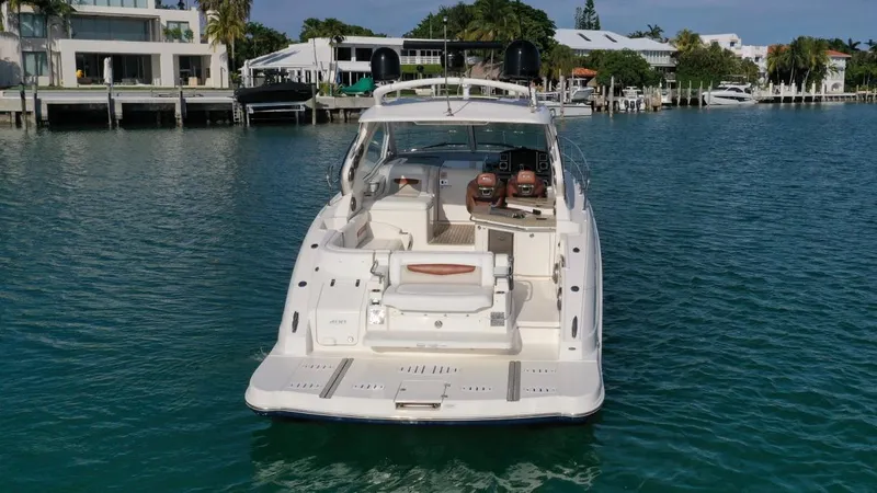  Yacht Photos Pics Chaparral Premiere 400 yacht, 2010 model, docked in a serene marina setting.