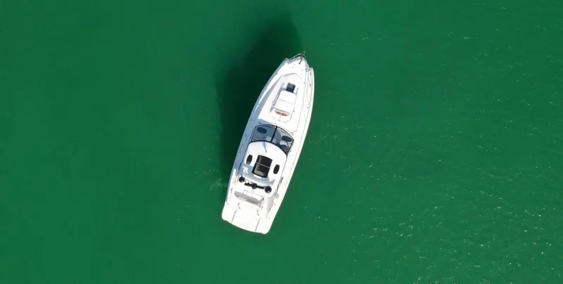  Yacht Photos Pics Aerial view of 2010 Chaparral Premiere 400 yacht on green water.