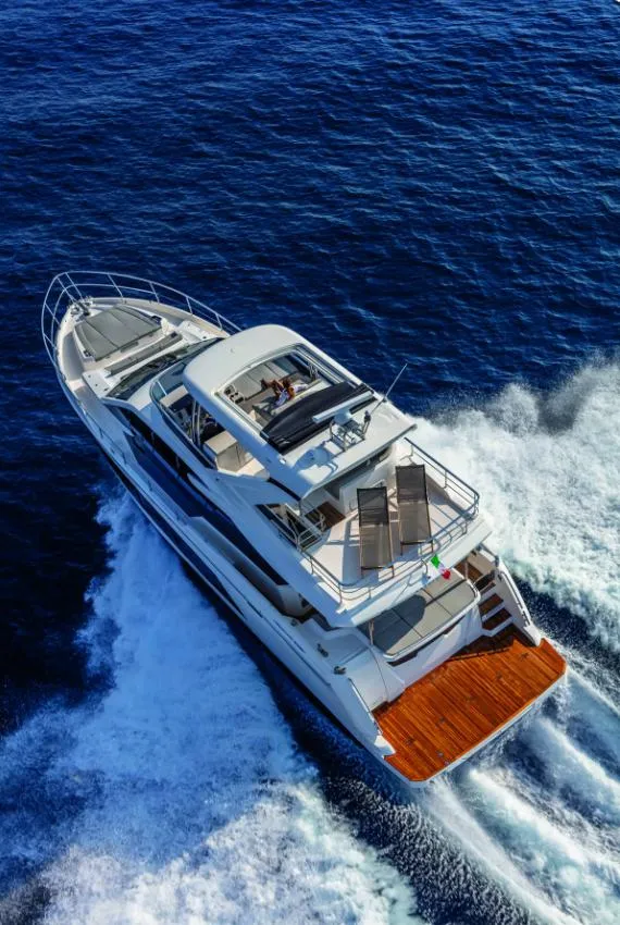 Luxury yacht cruising on open sea, Absolute Fly Co Ownership 2023 model.