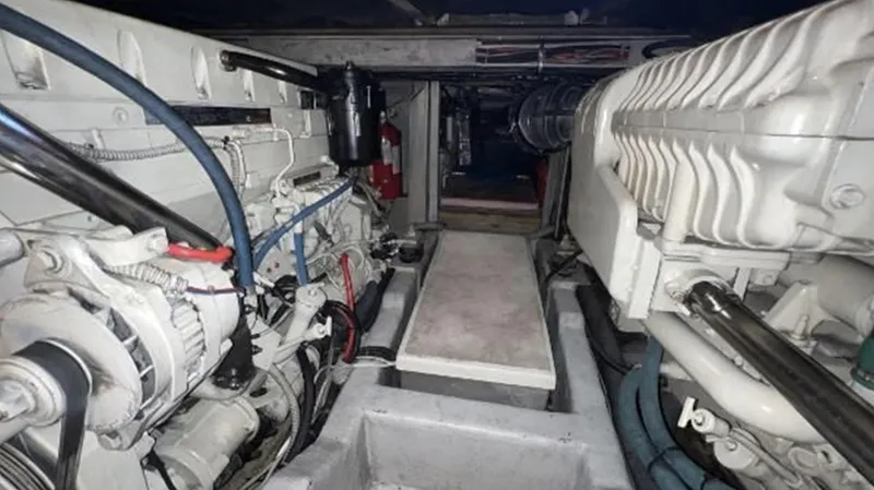 Blue Martini Yacht Photos Pics Engine room of 2001 Uniesse Flybridge 48 yacht, showcasing mechanical components and layout.