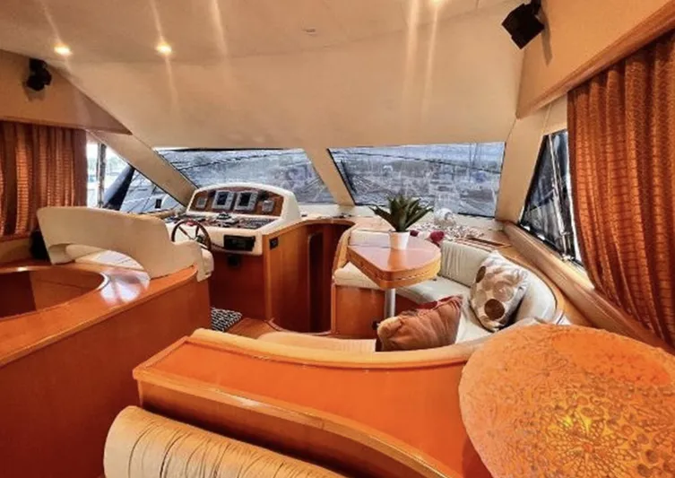 Blue Martini Yacht Photos Pics Luxurious interior of 2001 Uniesse Flybridge 48 yacht with elegant seating and helm.