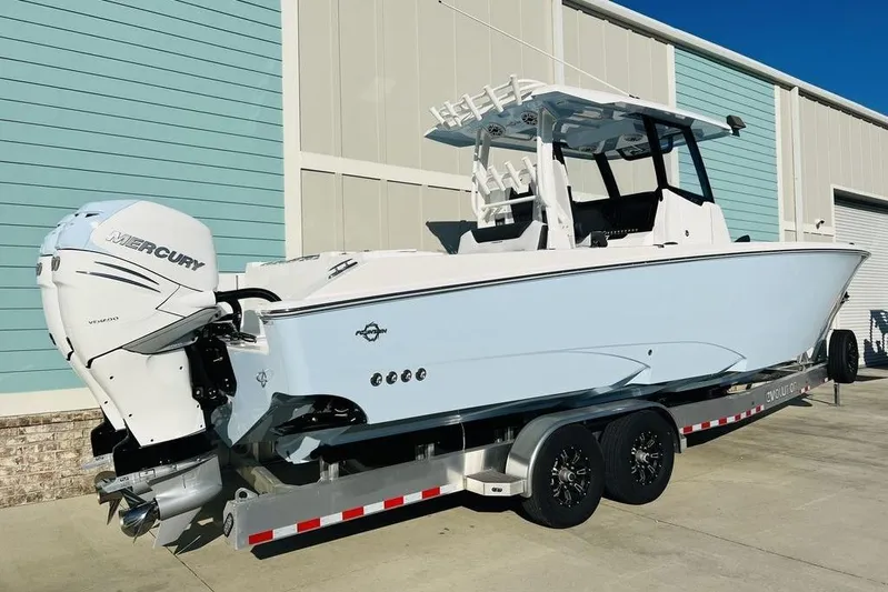 Yacht Photos Pics 2023 Fountain 32 NX boat with Mercury engine on trailer, parked outdoors.