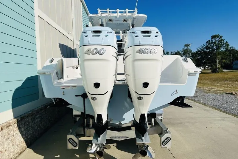  Yacht Photos Pics 2023 Fountain 32 NX boat with dual 400 horsepower engines, parked outdoors.