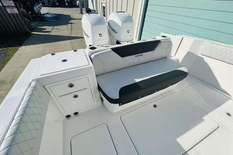  Yacht Photos Pics 2023 Fountain 32 NX boat interior with seating and storage compartments.