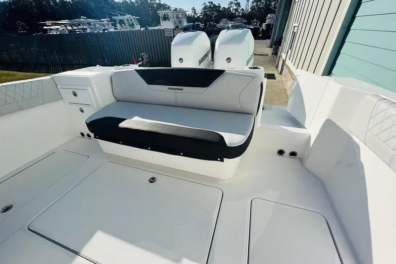  Yacht Photos Pics 2023 Fountain 32 NX boat interior with seating and storage compartments.