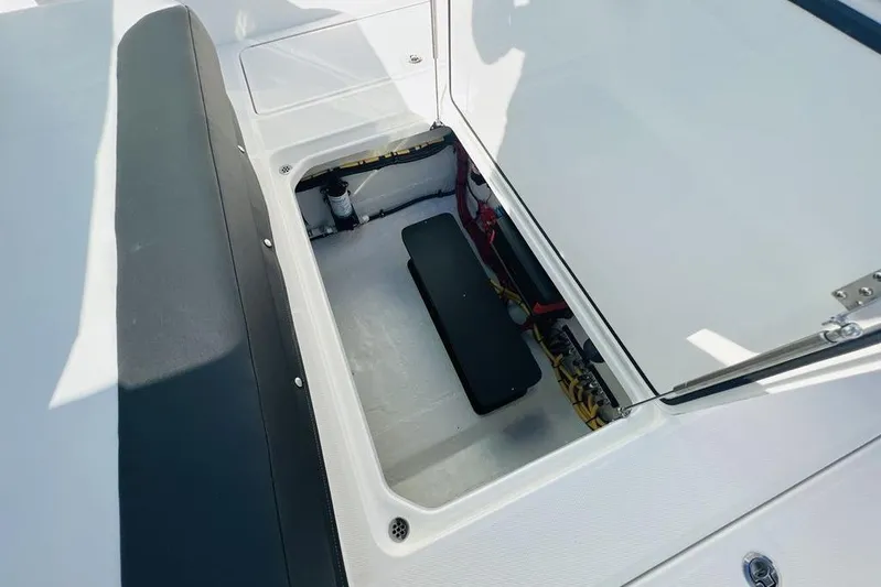  Yacht Photos Pics Open storage compartment on 2023 Fountain 32 NX boat, showcasing interior details.