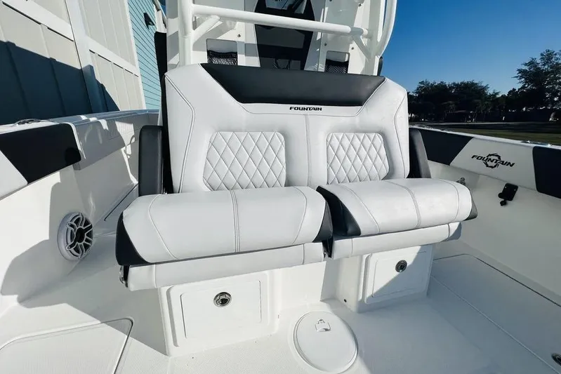  Yacht Photos Pics 2023 Fountain 32 NX boat seating with diamond-stitched upholstery and storage compartments.