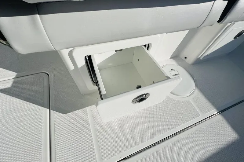  Yacht Photos Pics 2023 Fountain 32 NX boat interior with open storage compartment.