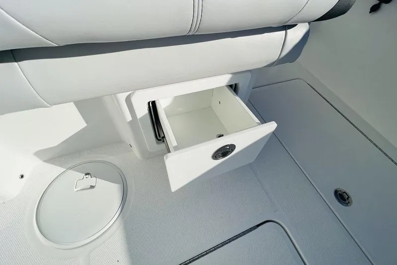  Yacht Photos Pics 2023 Fountain 32 NX boat interior with open storage compartment and seating.