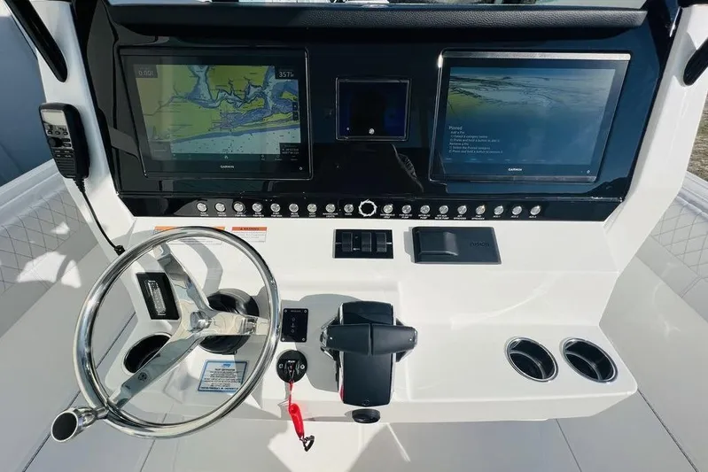  Yacht Photos Pics 2023 Fountain 32 NX boat dashboard with dual Garmin displays and steering wheel.