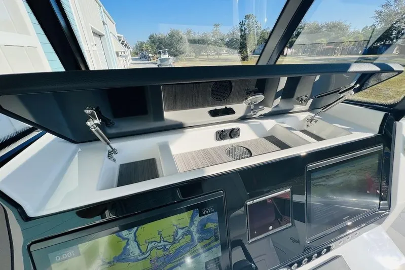  Yacht Photos Pics 2023 Fountain 32 NX boat dashboard with advanced navigation screens and storage compartments.