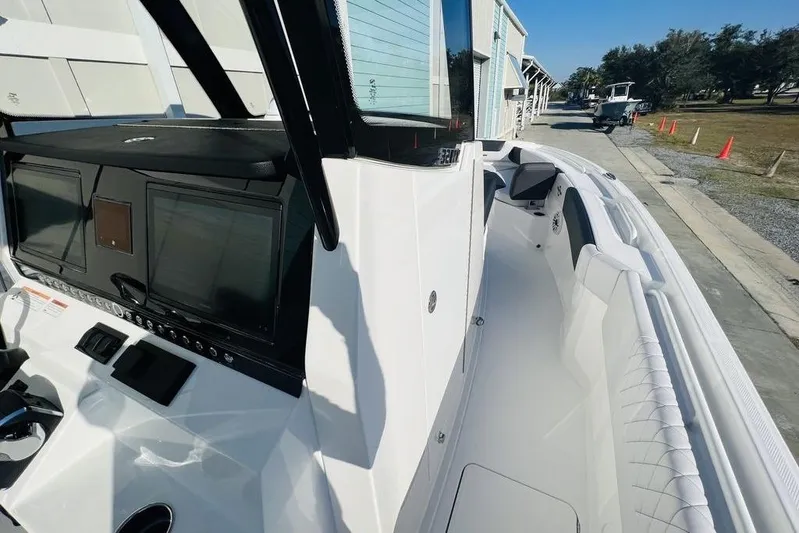  Yacht Photos Pics 2023 Fountain 32 NX boat interior with modern dashboard and seating.
