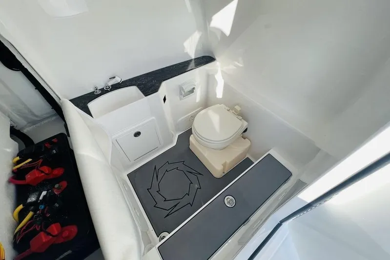  Yacht Photos Pics 2023 Fountain 32 NX boat interior with compact bathroom and modern amenities.