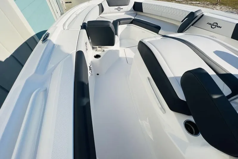  Yacht Photos Pics 2023 Fountain 32 NX boat interior with sleek white and black seating design.