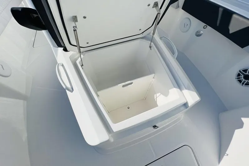  Yacht Photos Pics Open storage compartment on 2023 Fountain 32 NX boat, showcasing spacious interior design.