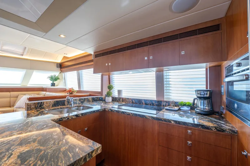 Island Girl Yacht Photos Pics Luxurious kitchen interior on 2016 Horizon PC52 yacht with modern appliances and elegant design.