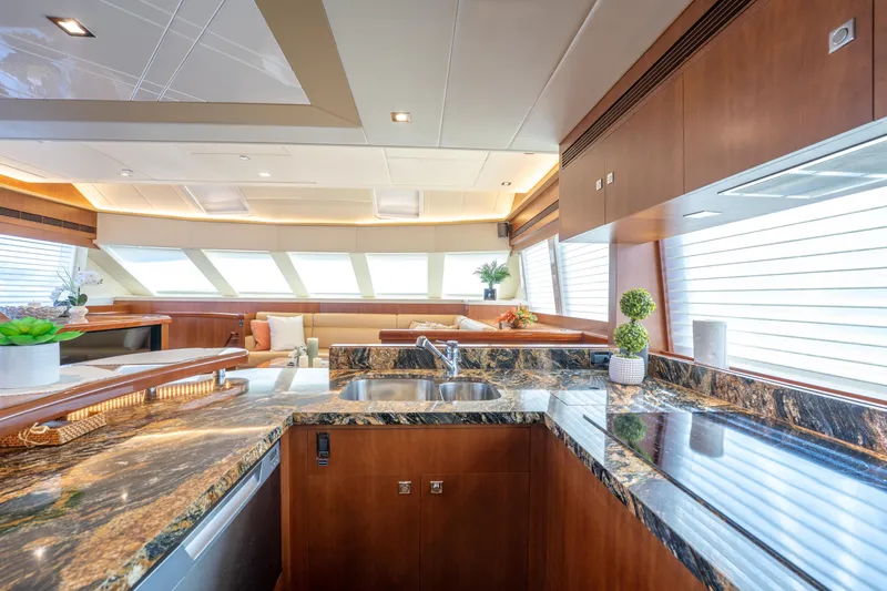 Island Girl Yacht Photos Pics Luxurious interior of 2016 Horizon PC52 yacht with elegant kitchen and seating area.