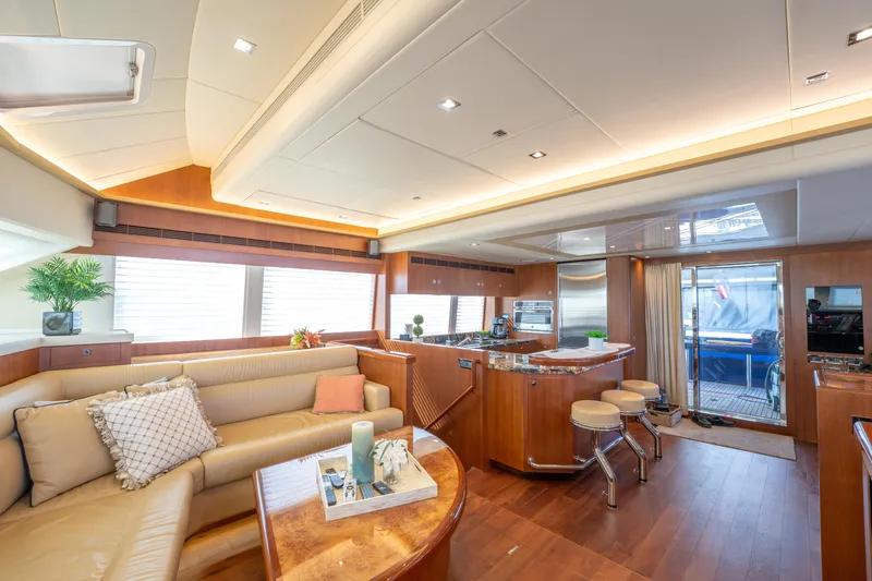 Island Girl Yacht Photos Pics Luxurious interior of 2016 Horizon PC52 yacht with modern kitchen and cozy seating area.
