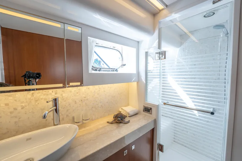 Island Girl Yacht Photos Pics Luxurious bathroom in 2016 Horizon PC52 yacht with modern fixtures and elegant design.