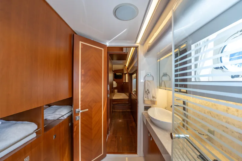 Island Girl Yacht Photos Pics Luxurious bathroom interior on 2016 Horizon PC52 yacht with modern fixtures and wood accents.