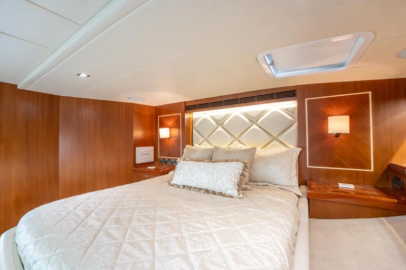 Island Girl Yacht Photos Pics Luxurious bedroom interior of 2016 Horizon PC52 yacht with elegant wood paneling.