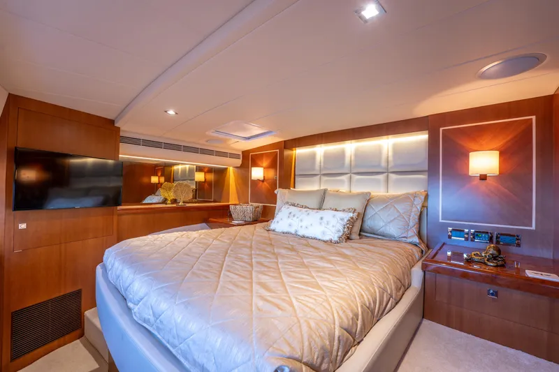 Island Girl Yacht Photos Pics Luxurious bedroom interior of 2016 Horizon PC52 yacht with elegant lighting and modern decor.