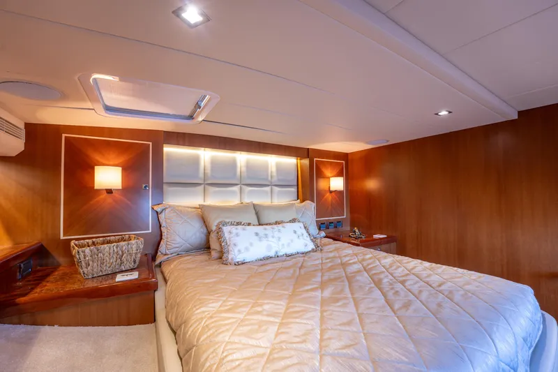 Island Girl Yacht Photos Pics Luxurious bedroom interior of 2016 Horizon PC52 yacht with elegant lighting and plush bedding.