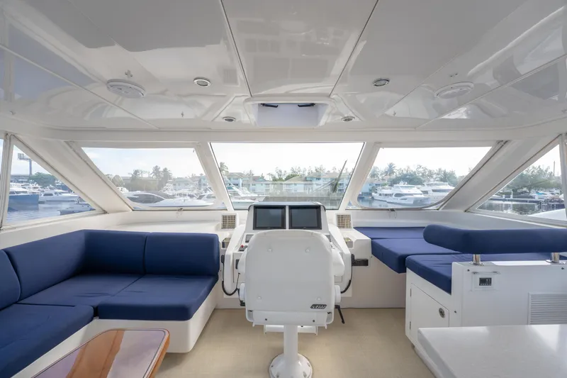 Island Girl Yacht Photos Pics Luxurious 2016 Horizon PC52 yacht interior with blue seating and panoramic windows.