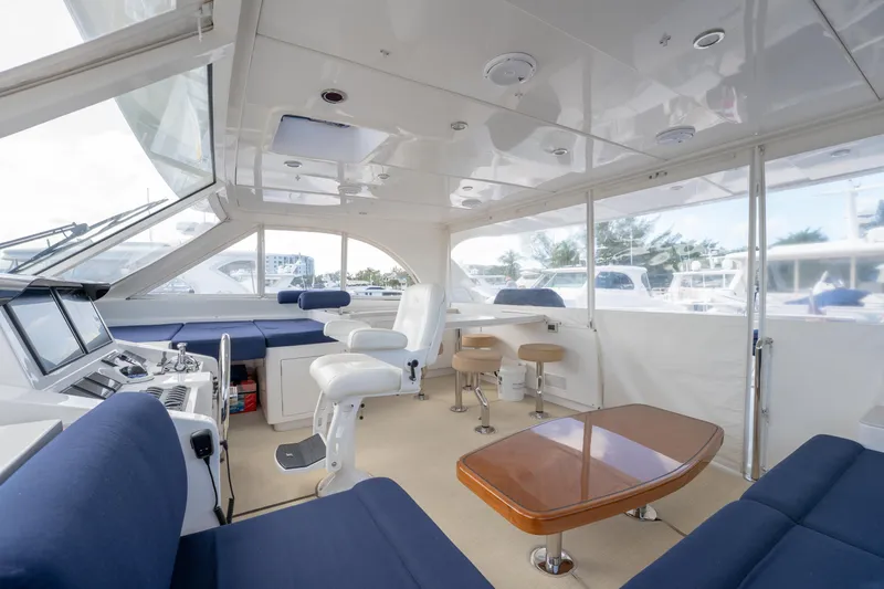 Island Girl Yacht Photos Pics Luxurious interior of 2016 Horizon PC52 yacht with modern seating and navigation area.