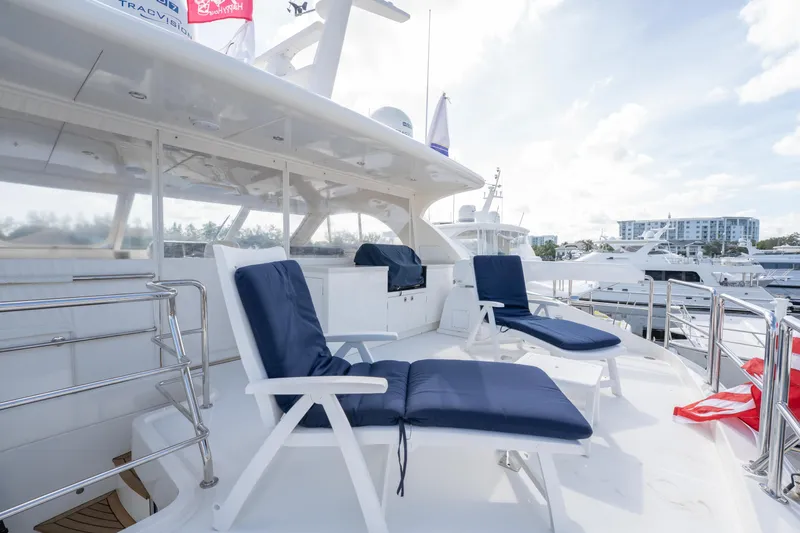 Island Girl Yacht Photos Pics Luxury Horizon PC52 yacht deck with blue cushioned chairs, 2016 model, docked at marina.