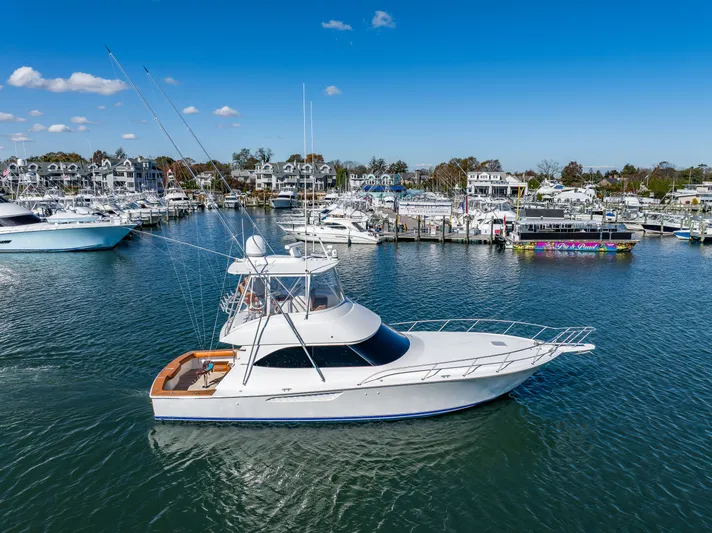 Amore Mia Yacht Photos Pics 2015 Viking 46 Convertible yacht docked in a marina under a clear blue sky.
