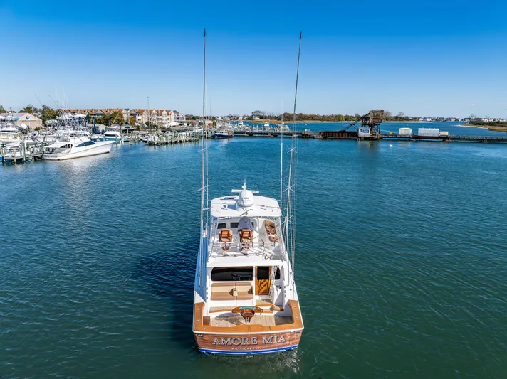 Amore Mia Yacht Photos Pics 2015 Viking 46 Convertible yacht on calm water near marina.