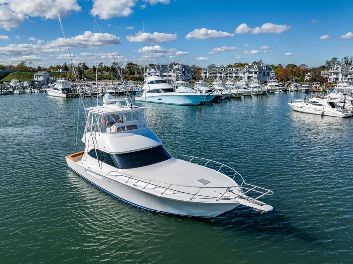 Amore Mia Yacht Photos Pics 2015 Viking 46 Convertible yacht docked in a marina under a clear blue sky.