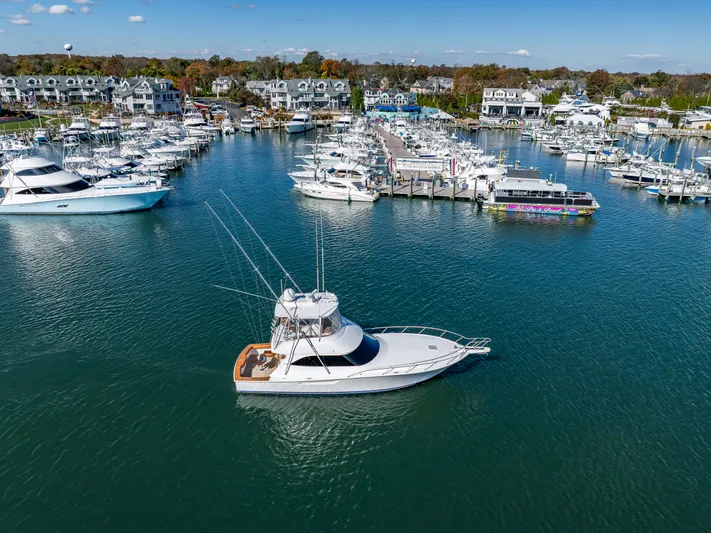 Amore Mia Yacht Photos Pics Aerial view of a 2015 Viking 46 Convertible yacht in a marina.
