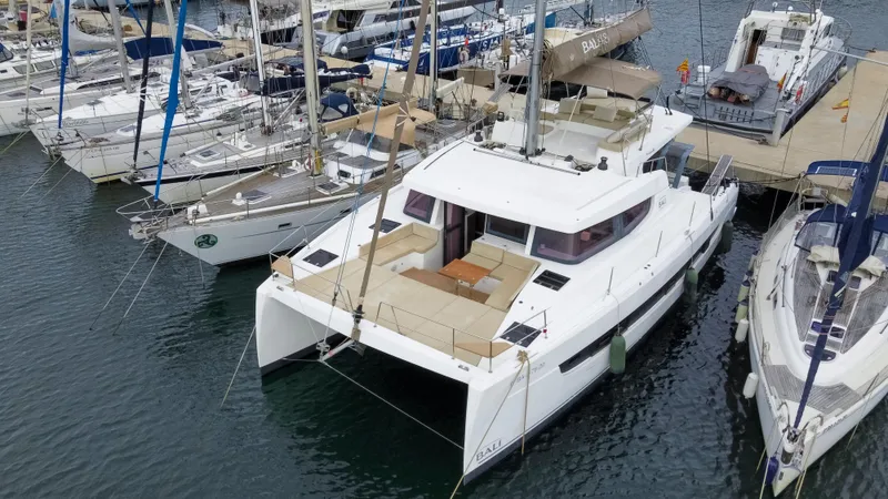 Tatani Yacht Photos Pics 2021 Bali 4.8 catamaran docked at marina, surrounded by other boats.