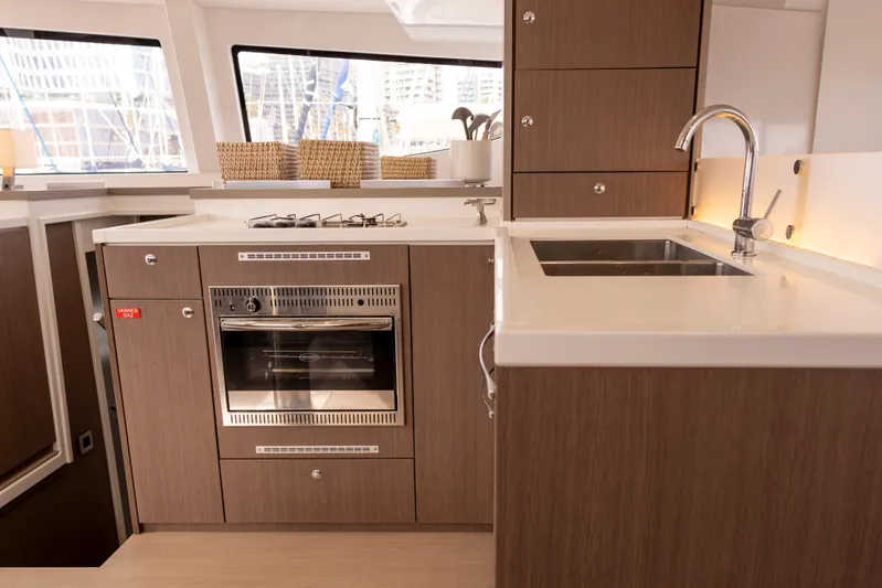 Tatani Yacht Photos Pics Modern kitchen interior on 2021 Bali 4.8 yacht with oven, sink, and storage cabinets.
