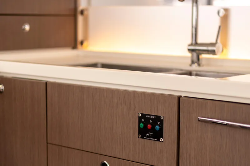 Tatani Yacht Photos Pics Modern kitchen sink area in a 2021 Bali 4.8 yacht, featuring sleek cabinetry and fixtures.