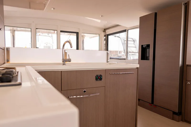 Tatani Yacht Photos Pics Modern kitchen interior on 2021 Bali 4.8 yacht with sleek cabinetry and large windows.