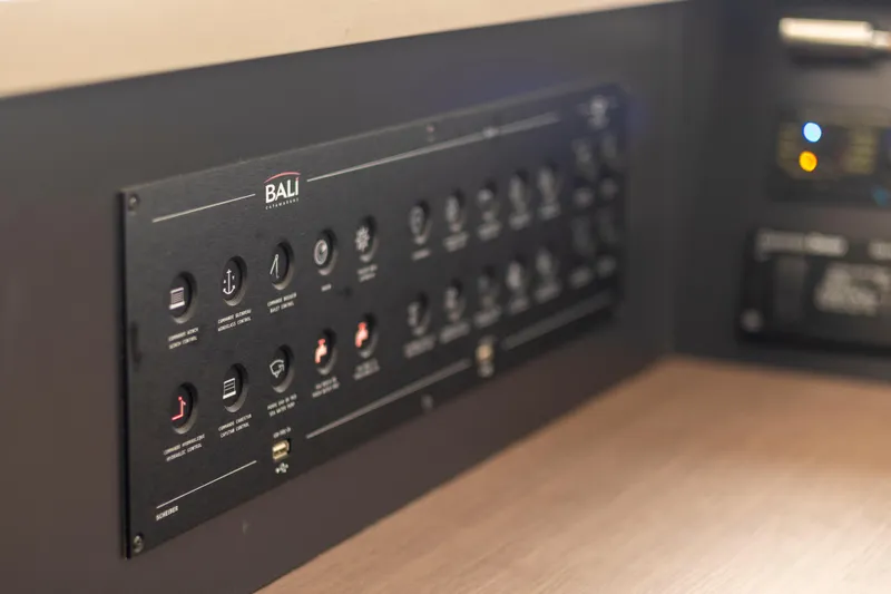 Tatani Yacht Photos Pics Control panel of a 2021 Bali 4.8 yacht, featuring various switches and indicators.