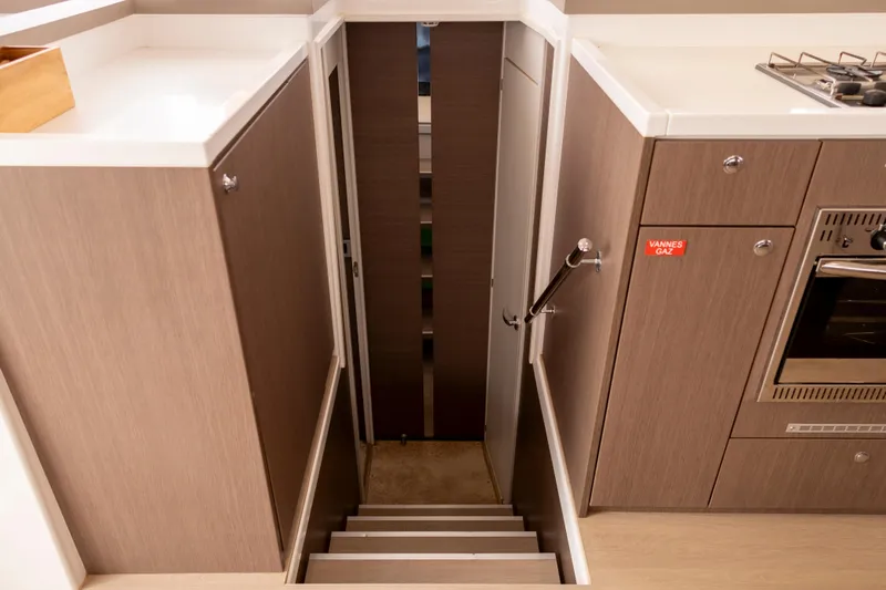 Tatani Yacht Photos Pics Staircase in 2021 Bali 4.8 yacht interior, featuring modern wood cabinetry and built-in oven.