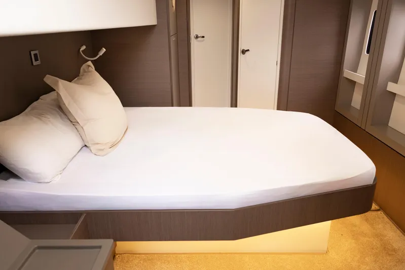 Tatani Yacht Photos Pics Modern bedroom interior in a 2021 Bali 4.8 yacht, featuring a cozy bed and elegant design.