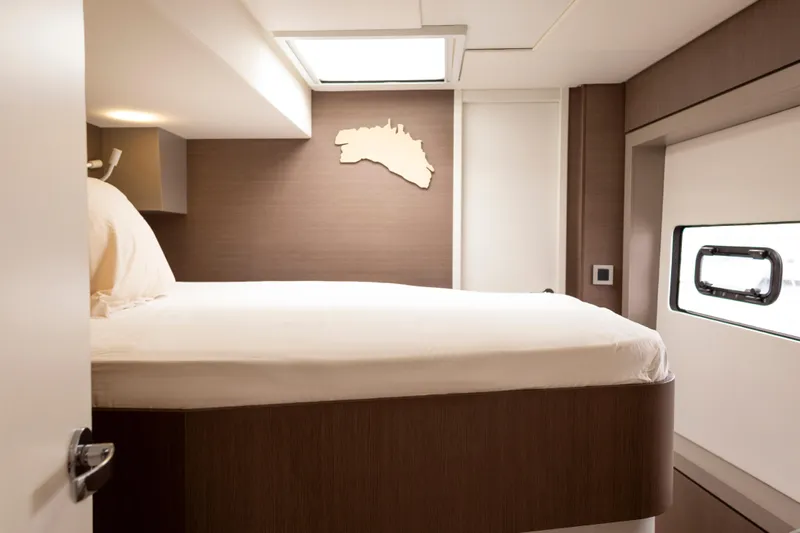 Tatani Yacht Photos Pics Interior cabin of a 2021 Bali 4.8 yacht with modern design and comfortable bedding.