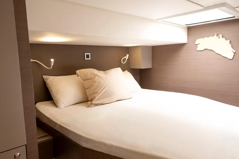 Tatani Yacht Photos Pics Luxurious cabin interior of 2021 Bali 4.8 yacht with cozy bed and modern lighting.