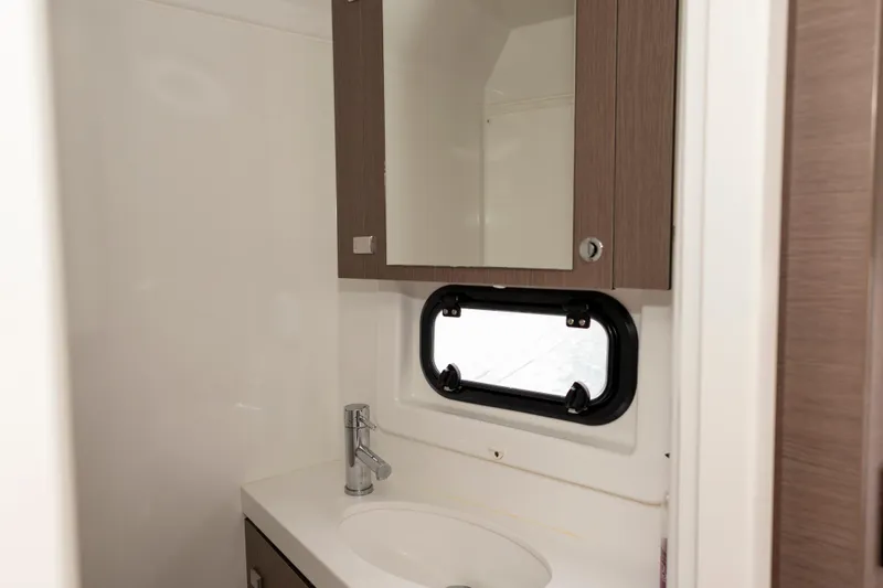 Tatani Yacht Photos Pics Compact bathroom in 2021 Bali 4.8 model with mirror and sink.